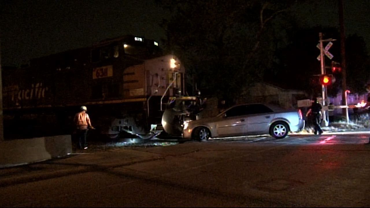 Train hits car stuck on railroad tracks